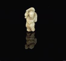 A Chinese carved celadon and grey jade figure of a small boy, early 20th century