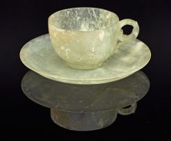 A Chinese carved pale celadon jade miniature cup and saucer, early 20th century