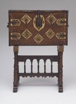 A Spanish iron-mounted parcel-gilt bone and walnut vargueno, 17th century, on later stand