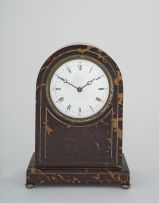 An Edwardian tortoiseshell and inlaid mantel clock