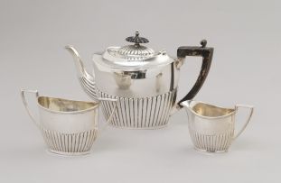 A Victorian silver three-piece bachelor's tea set, Walker & Hall, Sheffield, 1887