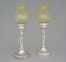 A pair of Victorian silver-plate candlesticks with glass shades