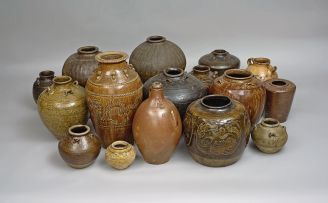 A miscellaneous group of thirteen South East Asian stoneware martavans and storage vessels, 17th/early 20th century