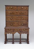 A Queen Anne walnut featherbanded and crossbanded chest-on-stand, early 18th century