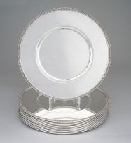 A set of twelve Christofle Malmaison pattern silver-plated underplates