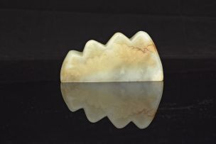 A Chinese carved celadon jade brush-rest, 19th century