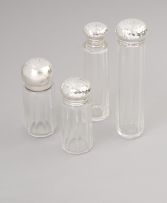 A set of three silver-mounted glass dressing table bottles, William Geiger, London, 1908