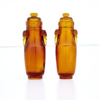 A near pair of Chinese amber-coloured glass snuff bottles, 20th century