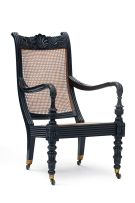 A Ceylonese ebonised and caned armchair, 19th century