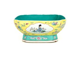 A Chinese famille-rose yellow-ground bowl, Qing Dynasty, 19th century