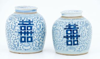 A near pair of Chinese blue and white jars and covers, 19th century