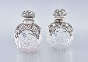 A near pair of Edward VII silver-mounted cut-glass scent bottles, Henry Matthews, Birmingham, 1906 and 1907