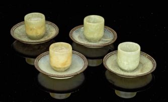 Four Chinese carved celadon jade cups and five metal-bound celadon jade saucers, early 20th century