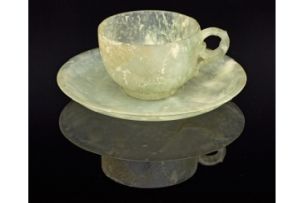 Four Chinese carved celadon jade cups and five metal-bound celadon jade saucers, early 20th century