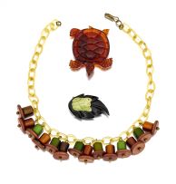 A amber-coloured carved bakelite 'turtle' dress clip