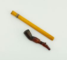 An amber and 'jewelled' cigarette holder, retailed by Abdulla & Co Ltd, 188 New Bond Street