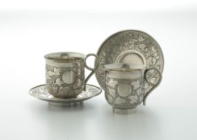 A pair of Chinese export silver cups and saucers, early 20th century