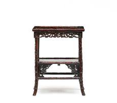 A Chinese carved hardwood two-tier table, first half 20th century