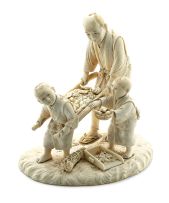 A Japanese ivory okimono of a farmer with two small boys, Meiji Period (1868-1912)