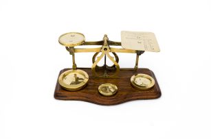 A late Victorian/early Edwardian brass postal scale and weights