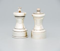 Two silver-plated pepper-grinders including a 