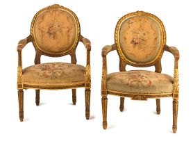 A pair of Louis XVI style giltwood fauteuils