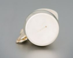 A silver cream jug, maker's initials NP, London, 1999