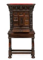 An Italian carved walnut and Bambocci cabinet, 18th century and later