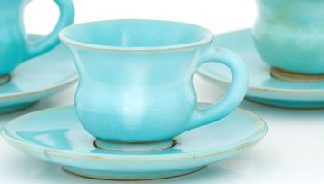 Four Linn ware turquoise-glazed coffee cups and saucers