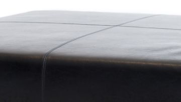 An Italian black leather ottoman, modern