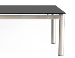 A black glass and brushed aluminium coffee table, modern