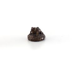 A Japanese wood netsuke of a frog on a lily pad, late Meiji Period (1868-1912)