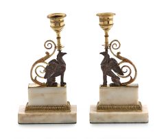 A pair of Regency bronze and parcel-gilt candlesticks
