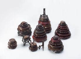 A miscellaneous group of twenty-eight Chinese hardwood and ebonised stands and covers, modern