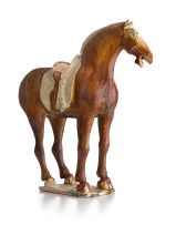 An amber-glazed pottery figure of a horse, Tang Dynasty