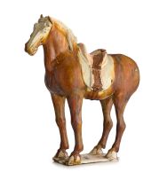 An amber-glazed pottery figure of a horse, Tang Dynasty