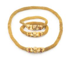 Gold repoussé and filigree 'makara' necklace and a pair of bracelets, en suite, South Indian, 19th century
