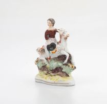 A Victorian Staffordshire figure of a young girl astride a goat