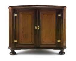A Cape stinkwood and yellowwod corner cupboard, 19th century and later