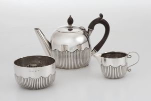 An assembled Victorian three-piece silver bachelor’s tea service, A & J Zimmerman Ltd, Birmingham, 1890-1892