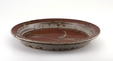 A Hyme Rabinowitz brown-glazed stoneware dish
