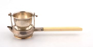 A George V silver and ivory novelty tea strainer and stand, Goldsmiths & Silversmiths Co Ltd, London, 1915