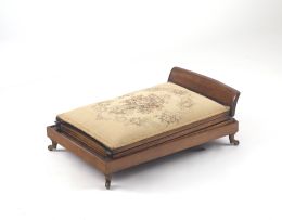 An Edwardian mahogany and upholstered gout stool,