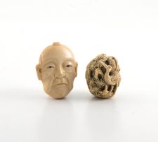 A Japanese carved ivory netsuke in the form of a Noh mask, Meiji period (1868-1912)