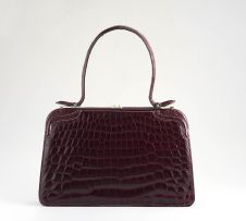 A French burgundy crocodile handbag, circa 1956