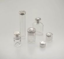 A miscellaneous group of six silver-mounted glass scent bottles, late 19th/early 20th century