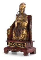 A Chinese lacquered wood and gilt figure of a dignitary, 17th/18th century