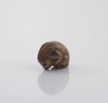 A Japanese wooden netsuke of a crouching hare, late Meiji period (1868-1912)