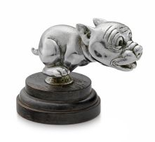 A nickel-plate Telcote pup mascot, Bonzo, British, 1930s