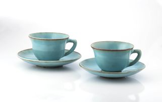 Two Linn Ware green-glazed teacups and saucers